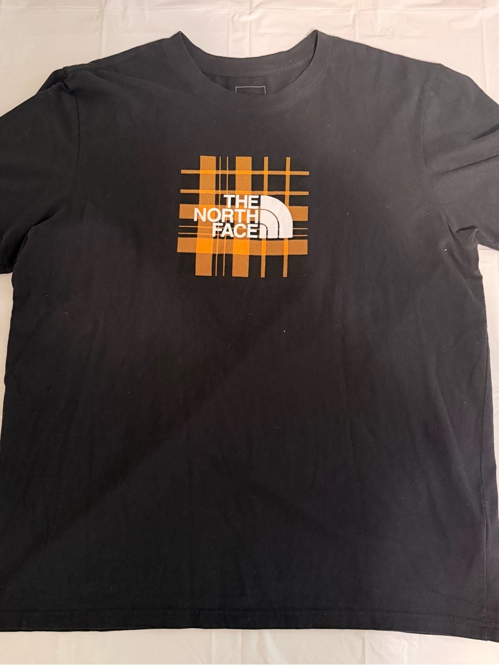 The North Face Black Tee with Orange Plaid Logo